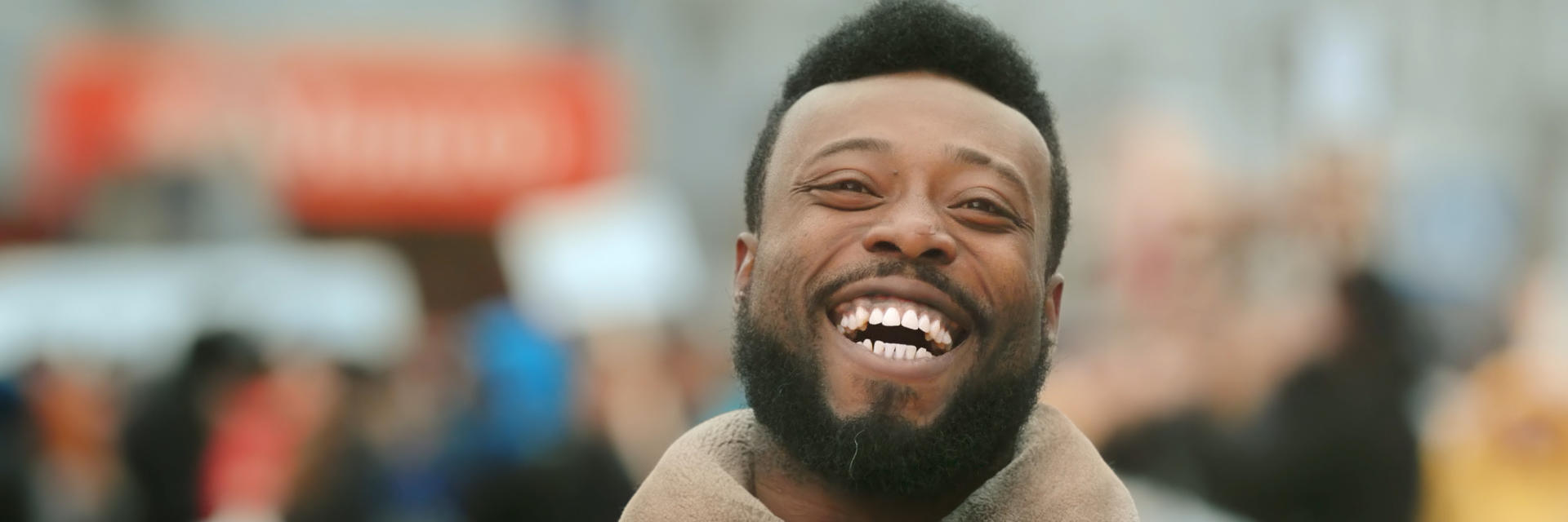 Happy Afro-American man showing nice teeth in his smile.