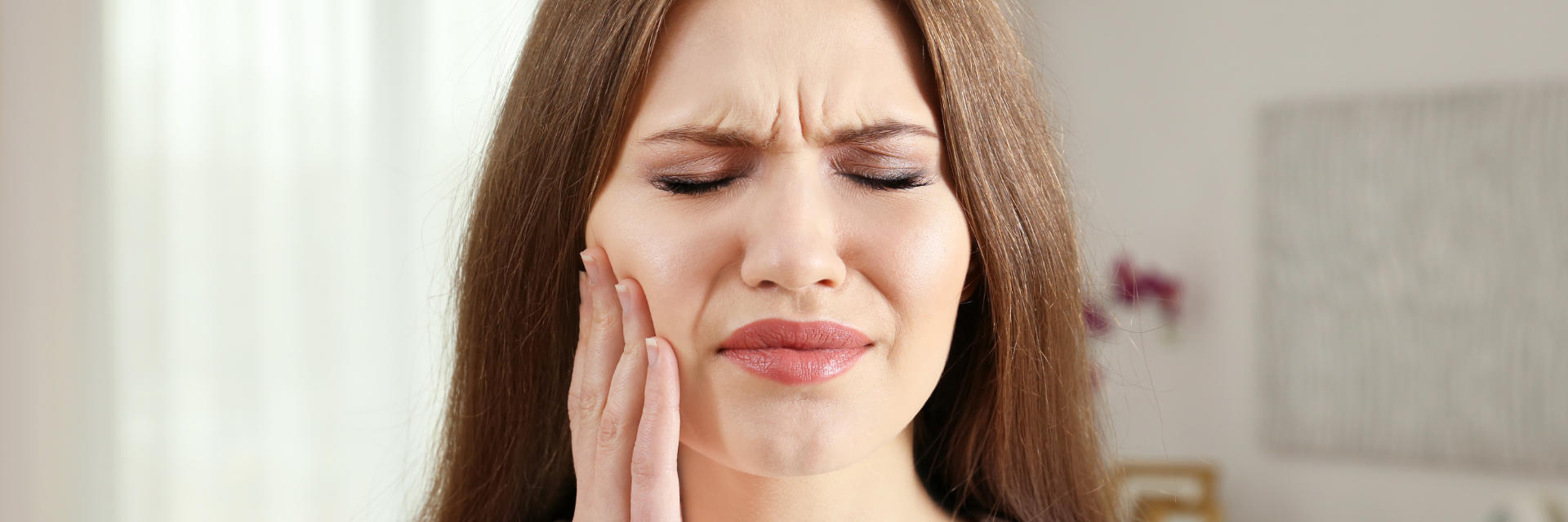 Woman suffering from dental pain.