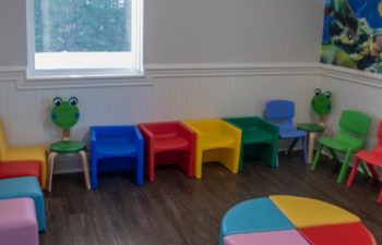 Kids waiting zone with colorful chairs at SmileBuilders, Inc.