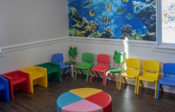 Kids waiting zone with colorful chairs at SmileBuilders, Inc.