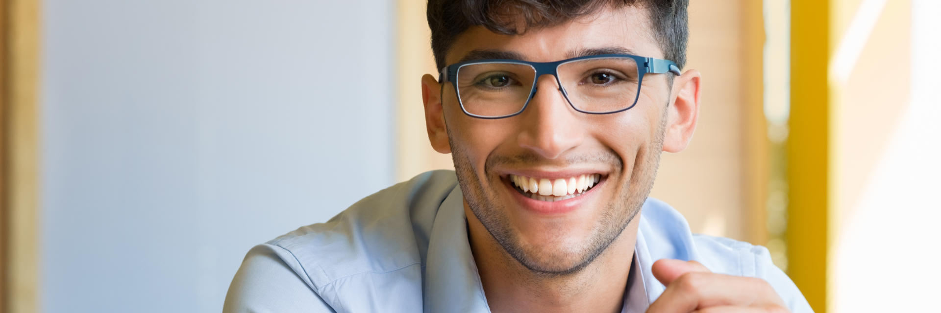 Young man wearing glasses with perfect smile.