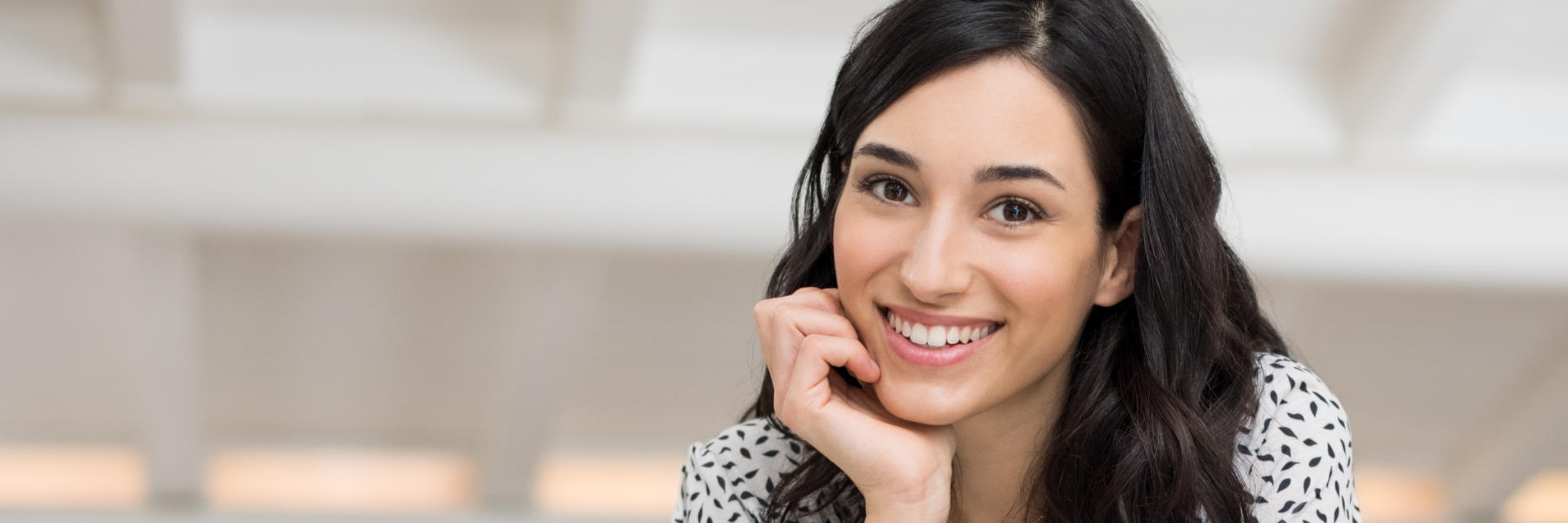 Beautiful young dark-haired woman with perfect smile.