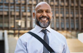 Happy mature man showing his perfect teeth in a smile.