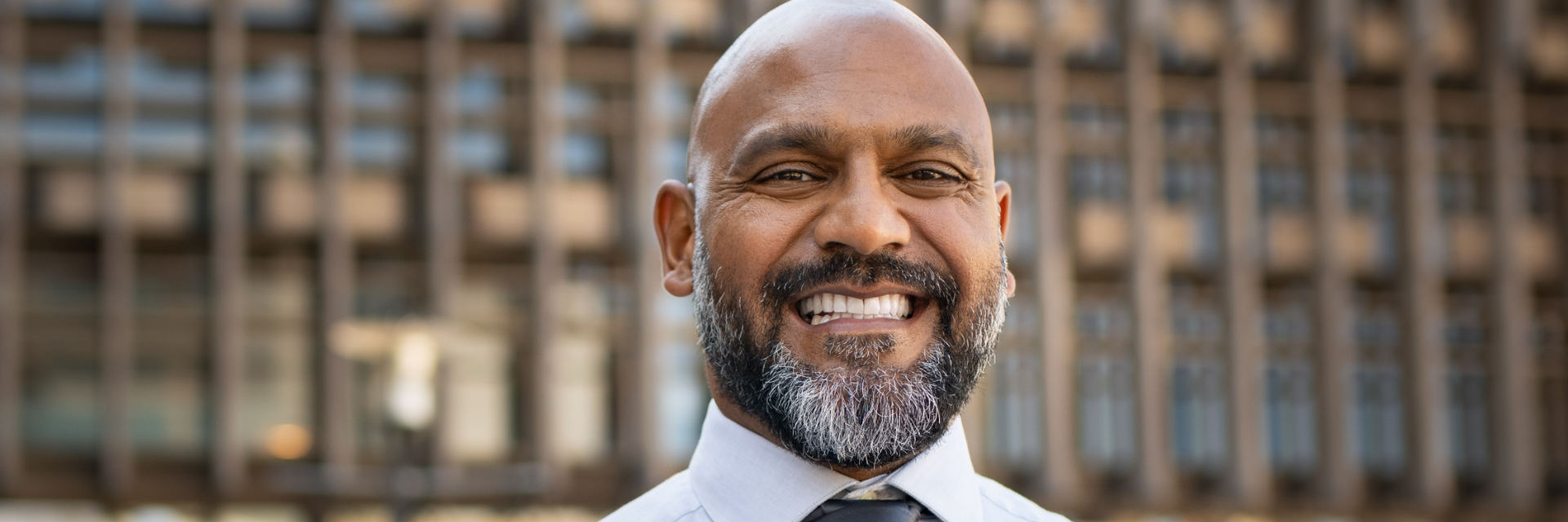 Happy mature man showing his perfect teeth in a smile.