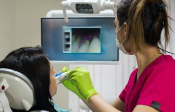 A dentist performing oral screening as a part of regular checkup.