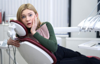 scared woman in dentist chair